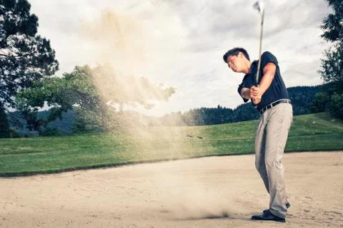 Golf player in sand trap. Stock Photos