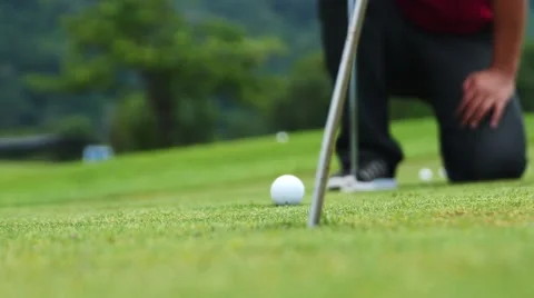 Golf player strikes ball on golf course Stockbeeldmateriaal 63825269