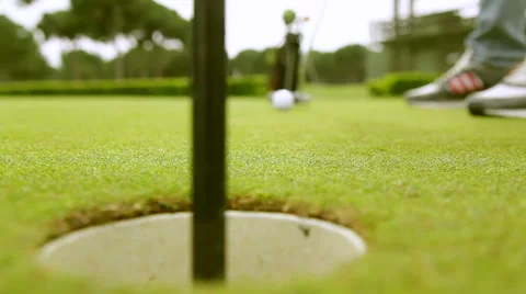 Golf player strikes ball on golf course Stock Footage 64877442