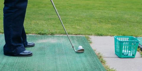 Golf player at tee off on a golf course Stock Photos