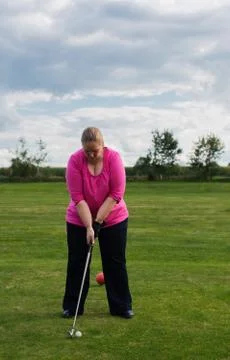 Golf player at tee off on a golf course Stock Photos