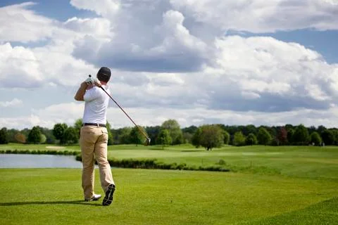 Golf player teeing off Stock Photos