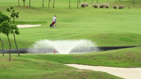 Golf player walking on a nice course Stock Footage 65454040