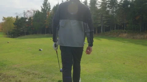 Golf Player Walks Towards the Hole on the Green Golf Course 4K Stock Footage 300468409