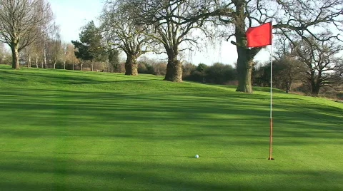 Golf Pole Flag Flapping in the Wind with Ball Stock Footage 264429