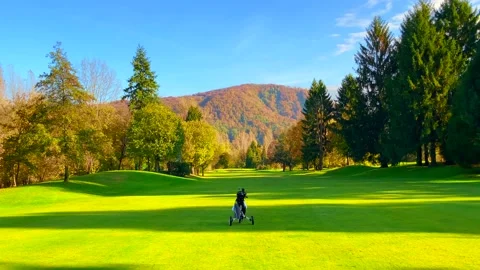 Golf Push Cart with Golf Bag Travel Alone on the Golf Course in a Sunny Day Stock-Footage 165201364