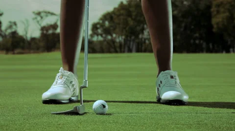 Golf putter hitting a ball Stock Footage 32529046