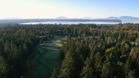 Golf resort grounds, mountains and forest in background. 動画素材 88045741