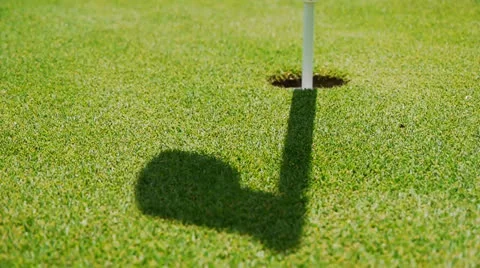 Golf - shadow from target flag moving in the wind Stock Footage 23113629