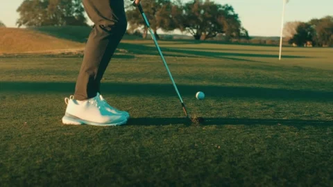 Golf Shoe Slow Motion Chip Shot Putting Green Pin Sunset Tree Background White Stock Footage 334565662