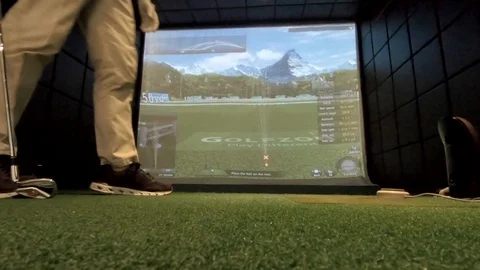 Golf simulator ball strike from ground level behind ball Stock Footage 111871929