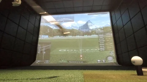 Golf simulator ball strike from ground level behind ball Stock Footage 111871982