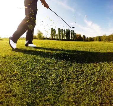 Golf swing on the course. Golfer performs a golf shot from the f Stock Photos