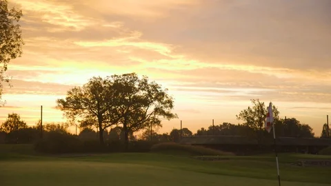 Golfcourse Flag At Sunrise With A Big Tree Stock Footage 127036032