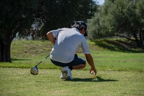 Golfer accommodating ball in tournament. Stock Photos