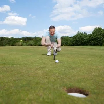 Golfer aiming at golf course Photos
