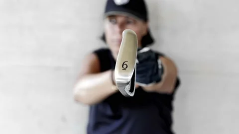 Golfer with Cap Holding Up Her Golf Club Iron 6 in a Sunny Day Stockbeeldmateriaal 203484635