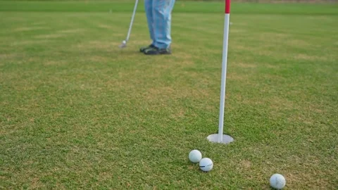 A Golfer Concentrating While Putting on the Green Under a Beautiful Clear Blue Stock Footage 346360001