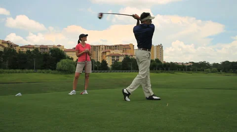 Golfer drives ball off tee Stock Footage 36764583