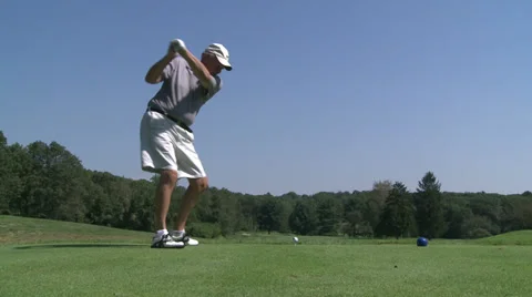 Golfer driving ball down fairway Stock Footage 32326460