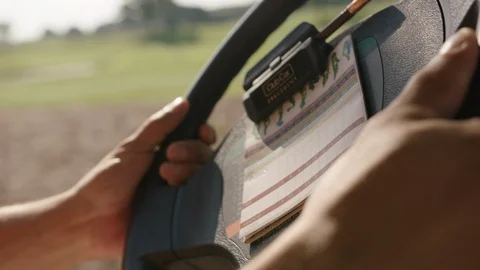Golfer. Driving golf cart to next tee. Wheel and scorecard cu Stock Footage 101708192