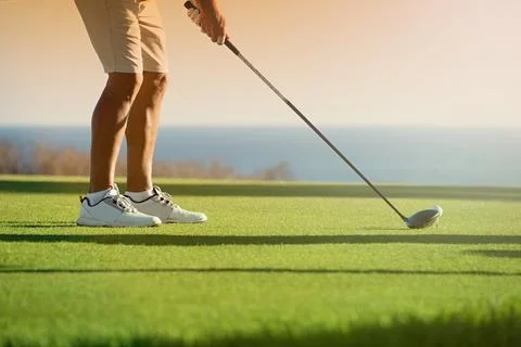 Golfer is going to tee off at sunset Stock Photos