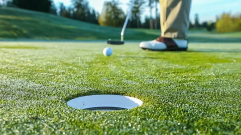 Golfer on the green sinks a close putt Stock-Footage 243447024