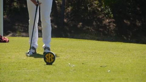 Golfer hits iron tee shot at SEC golf collegiate event Stock Footage 99984369