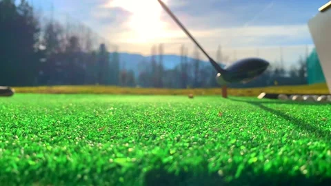 Golfer Hitting the Golf Ball with Driver on Mat in Driving Range Stockbeeldmateriaal 191935822