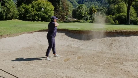 Golfer Hitting the Golf Ball From Sand Trap to Putting Green in a Sunny Day Stockbeeldmateriaal 211403354
