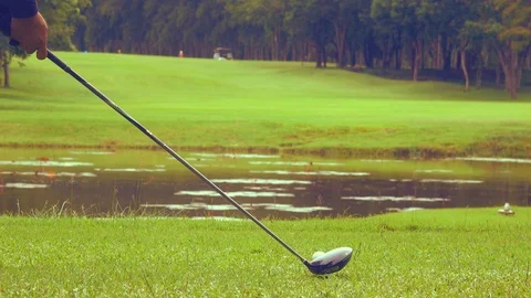 Golfer hitting golf ball on tee off zone in golf course Stock Footage 88407916