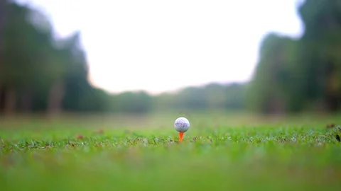 Golfer hitting golf ball on tee off zone in beautiful golf course  Stock Footage 94164296