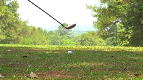 Golfer hitting golf ball on tee zone in golf course Stock Footage 107511925