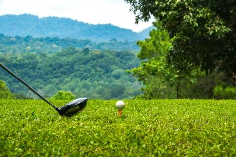Golfer hitting golf ball on tee off zone  Stock Photos