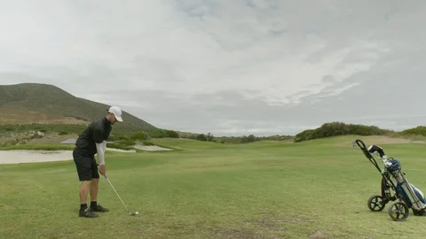 Golfer hitting golf shot on summer vacation Video stock 129379728
