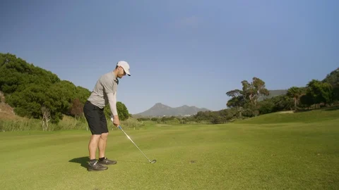 Golfer hitting golf shot on summer vacation Video stock 129380800