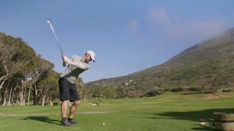 Golfer hitting golf shot on summer vacation Video stock 129381694