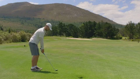 Golfer hitting golf shot on summer vacation Video stock 129382702