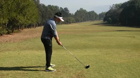 Golfer kicks the golf ball on the course Stock Footage 146466892