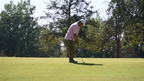 Golfer kicks the golf ball on the course Stock Footage 146468099