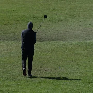Golfer lining up his stroke Stock Photos