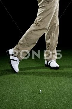 A golfer, low section, studio shot Stock Photos