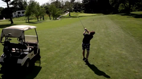 Golfer Making Shot on Golf Course Tracking Ball Stock Footage 29566771