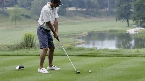 Golfer performing a golf swing in slow motion Stock Footage 71544563