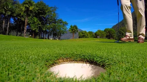 Golfer Picking Up the Golf Ball from the Golf Hole on the Golf Green Stock Footage 111323906