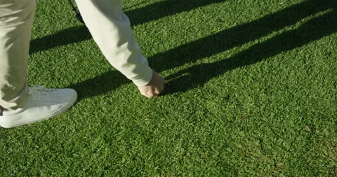 Golfer Places Tee into Grass Stock Footage 192344487