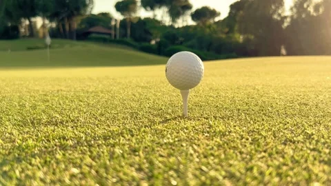 Golfer placing golf ball on the tee at golf course before shot Stock Footage 197393936