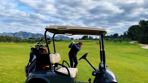 Golfer Playing on Golf Course with His Golf Cart. 動画素材 111574087