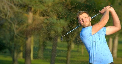 A Golfer plays out of a sand trap in slow motion. Vídeo Stock 103584643