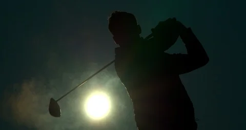A Golfer plays a shot at Sunrise/Sunset. Vídeos de archivo 103280933